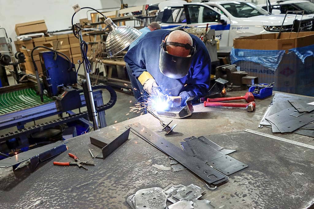 Pro-gard employee welding in the shop